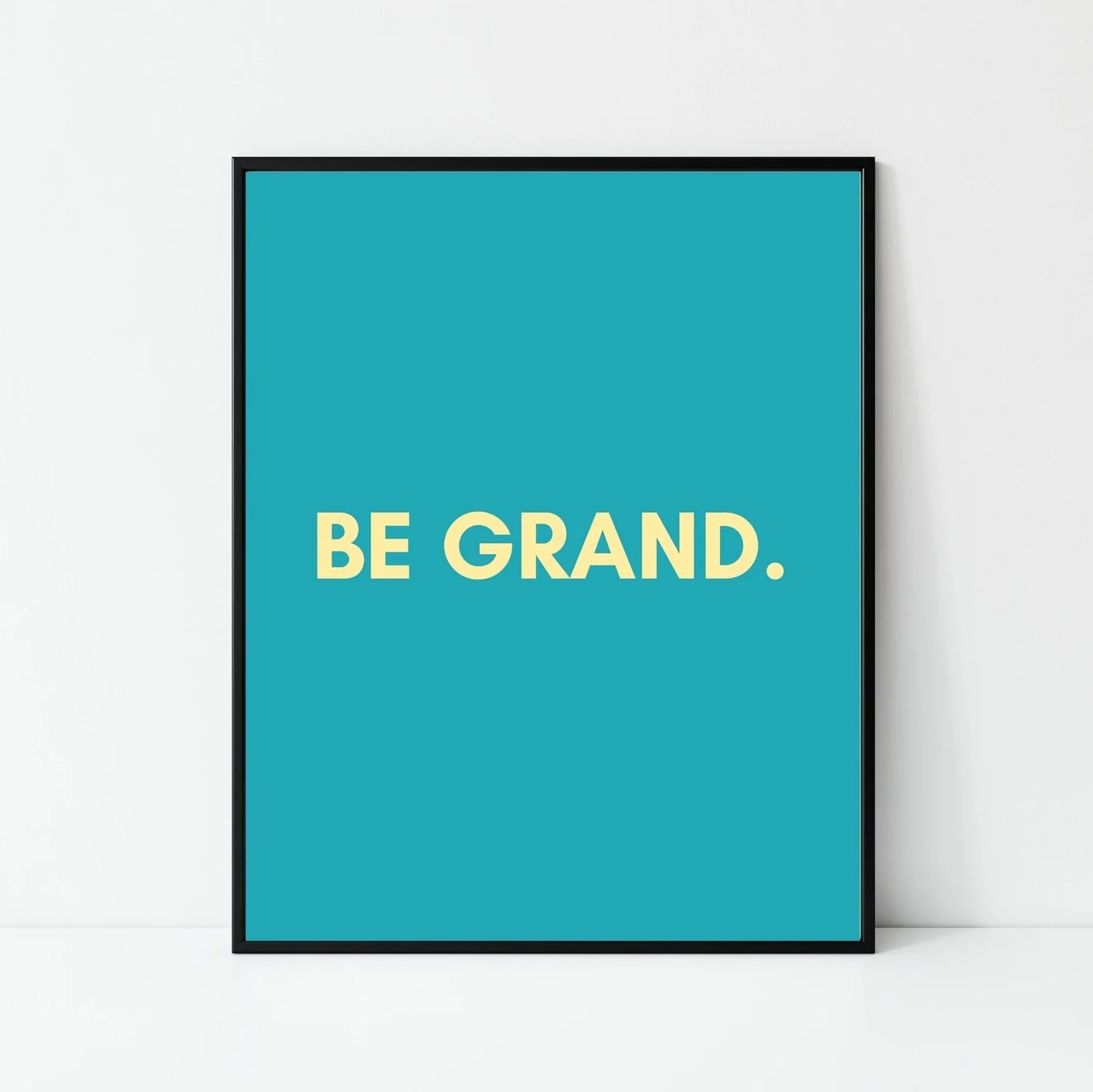 An A4 print with the words Be Grand against a blue background.